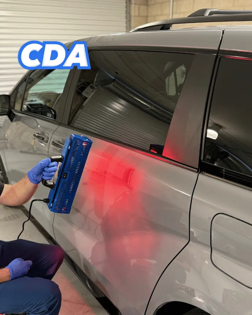 CDA auto styling technician curing ceramic coating on a door using infrared lamp in Riverside CA