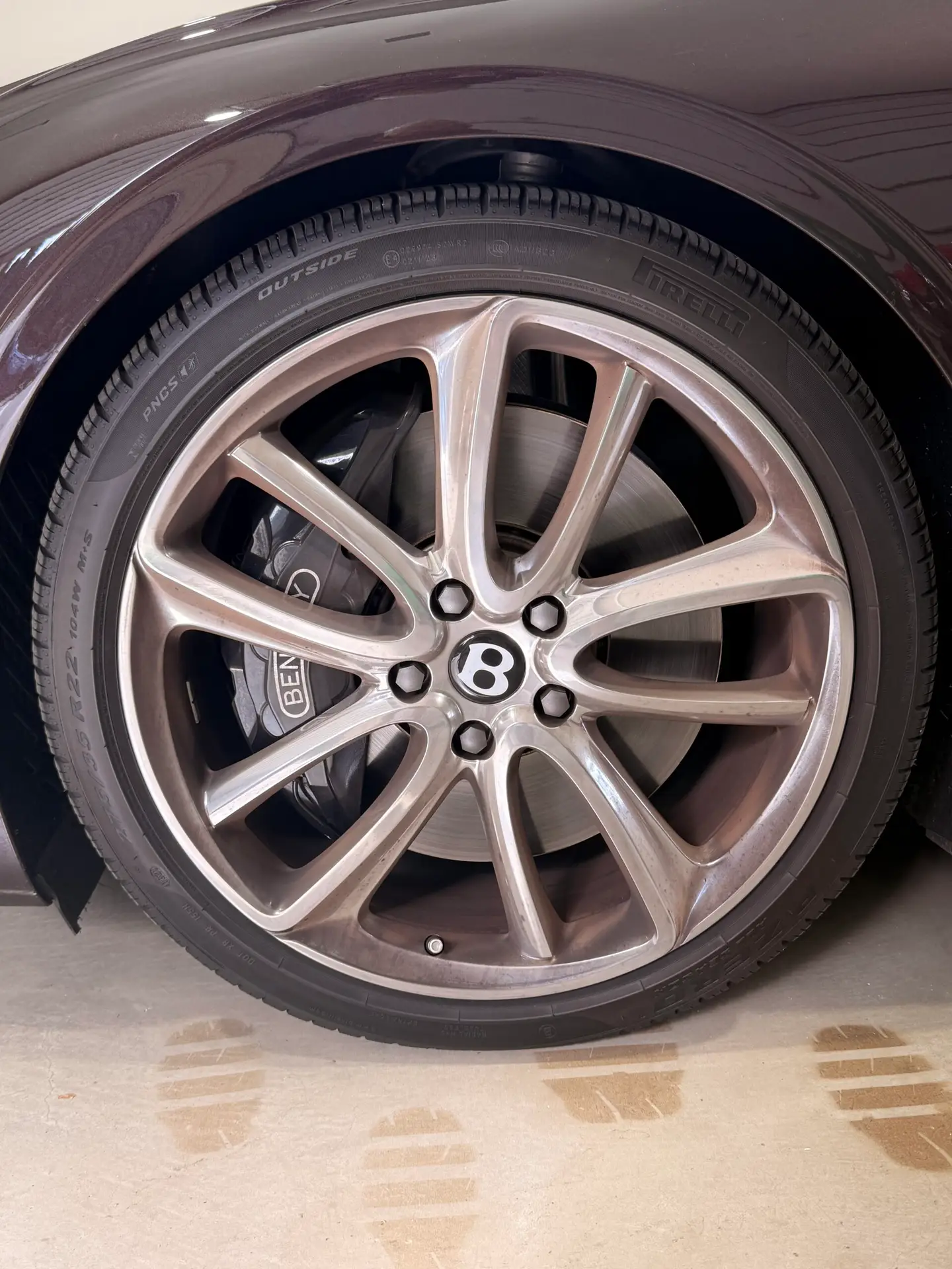 Bentley wheel before rim detailing and deep cleaning during mobile card detailing service in Riverside, California